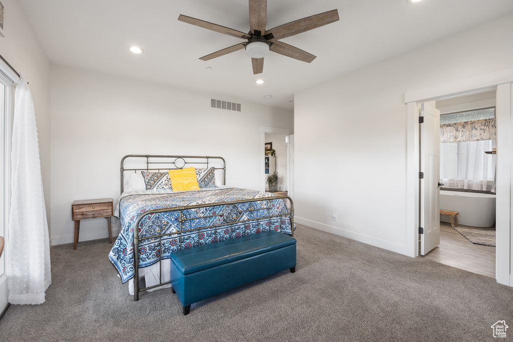 Bedroom featuring ceiling fan, carpet, and ensuite bathroom