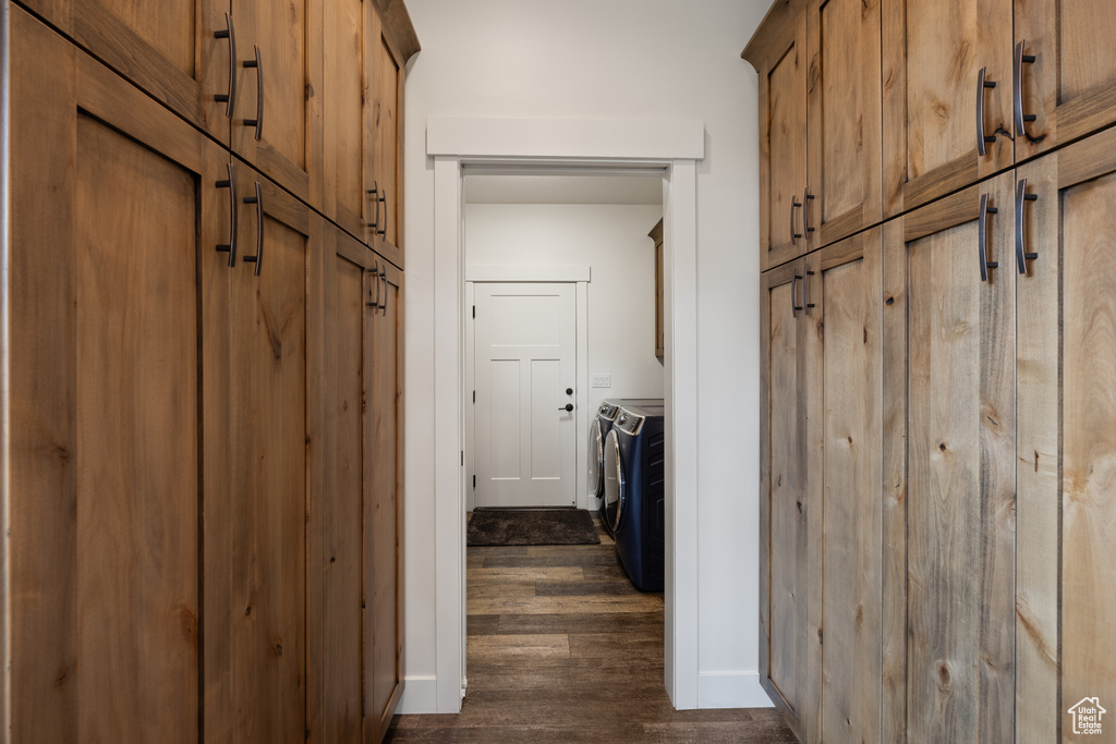 Interior space with dark hardwood / wood-style flooring and washer and dryer