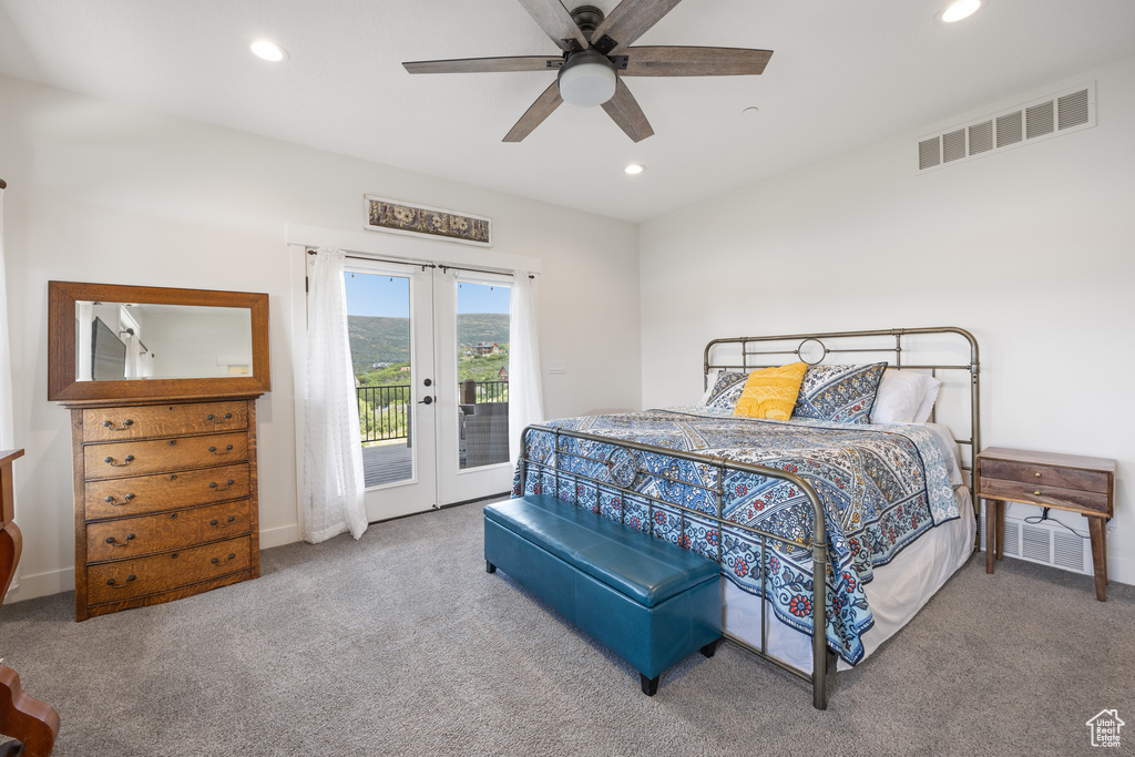 Carpeted bedroom featuring ceiling fan, french doors, and access to exterior