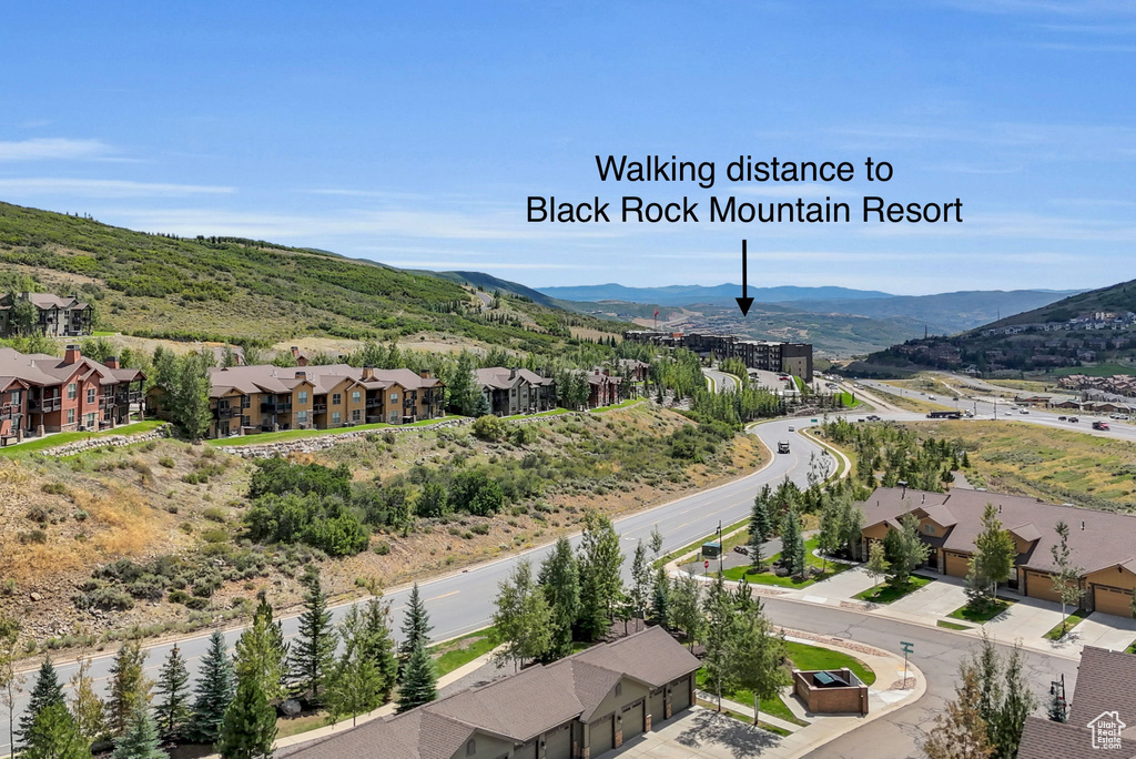 View of mountain backdrop featuring nearby suburban area