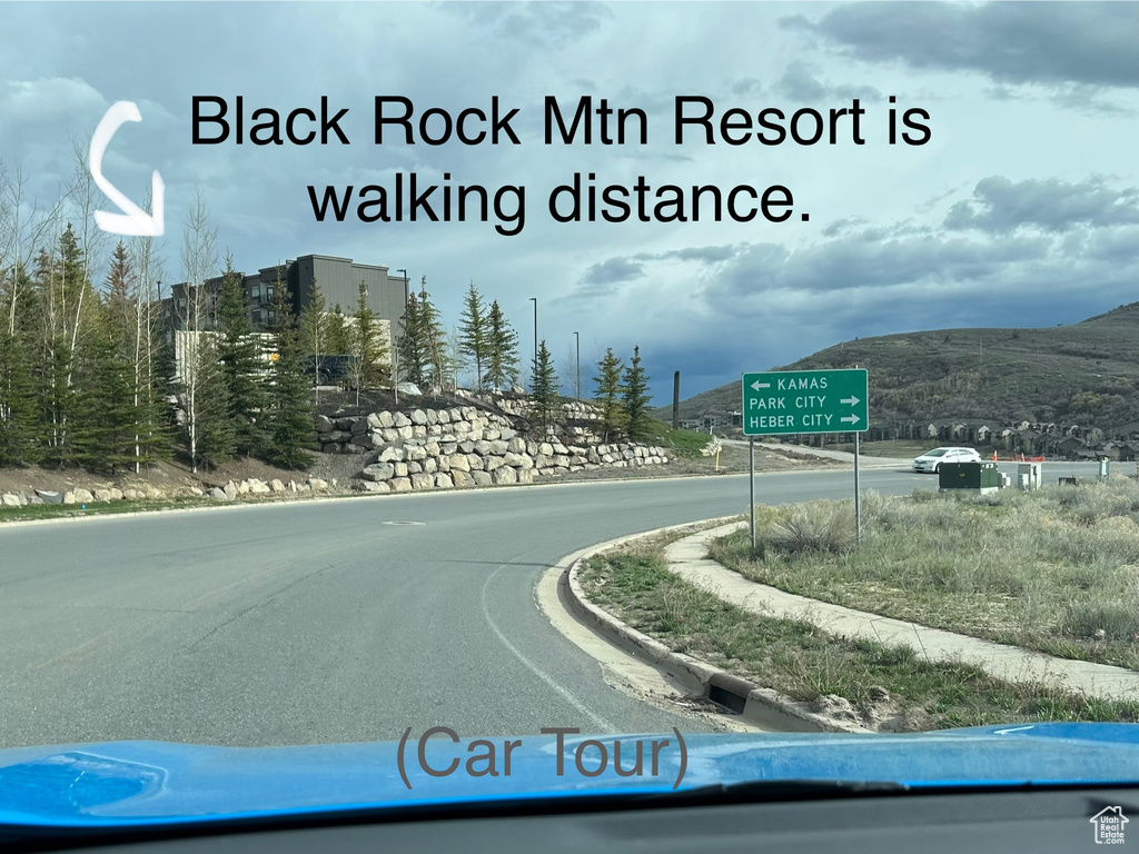 View of road featuring a mountain view and curbs