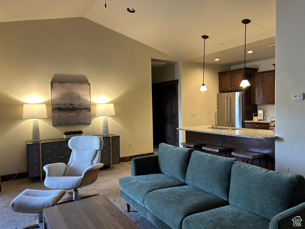 Living area with baseboards, carpet flooring, lofted ceiling, and recessed lighting