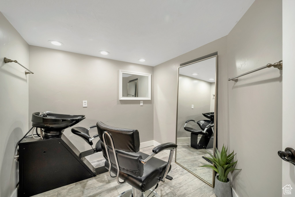 Workout area with light wood-type flooring