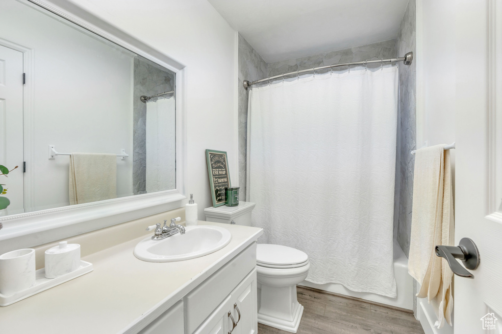 Bathroom with wood-type flooring, toilet, and vanity