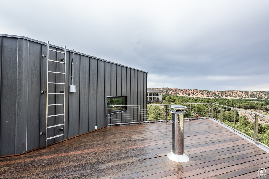 Wooden terrace featuring a mountain view