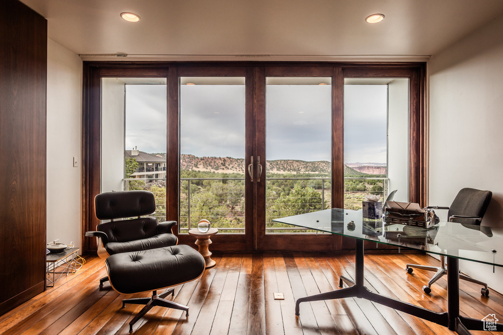 Home office featuring light hardwood / wood-style flooring and a wall of windows