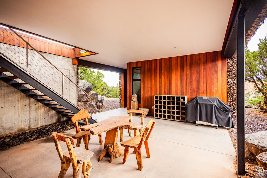 View of patio with a grill