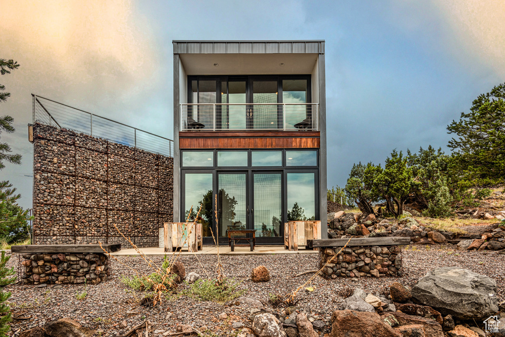 Back of house featuring a balcony