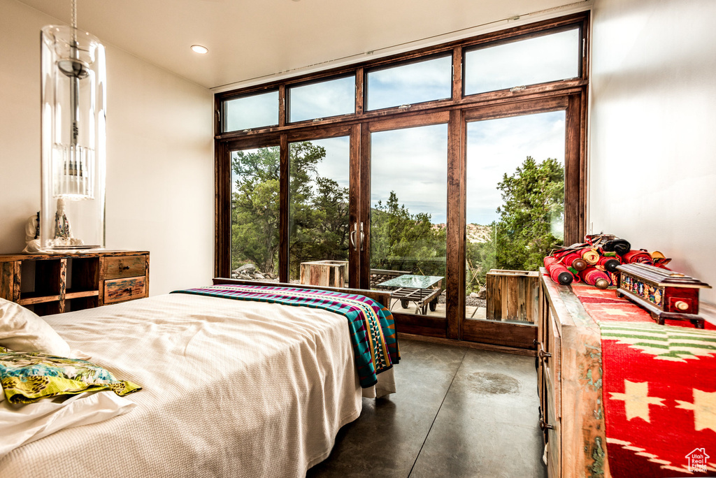 Bedroom with concrete flooring and access to exterior