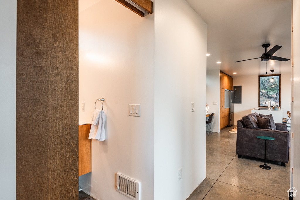 Hall featuring light tile patterned floors and electric panel