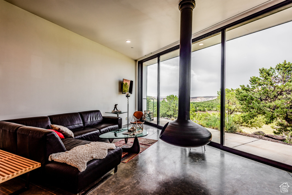 Living room with concrete floors and floor to ceiling windows