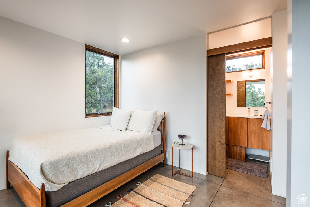 Tiled bedroom featuring multiple windows