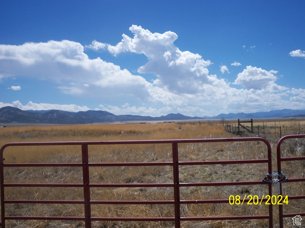 View of yard featuring a rural view and a mountain view