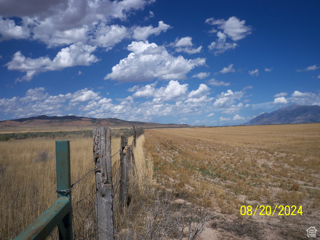 View of yard with a rural view and a mountain view