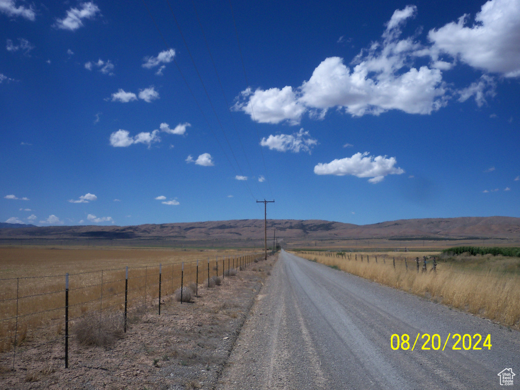 View of street with a rural view and a mountain view