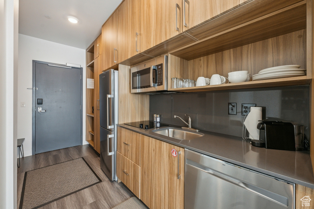 Kitchen featuring sink, light hardwood / wood-style flooring, and stainless steel appliances