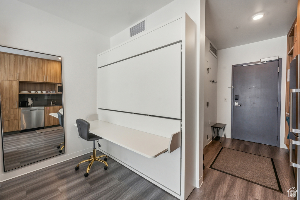 Office space with sink and dark hardwood / wood-style flooring