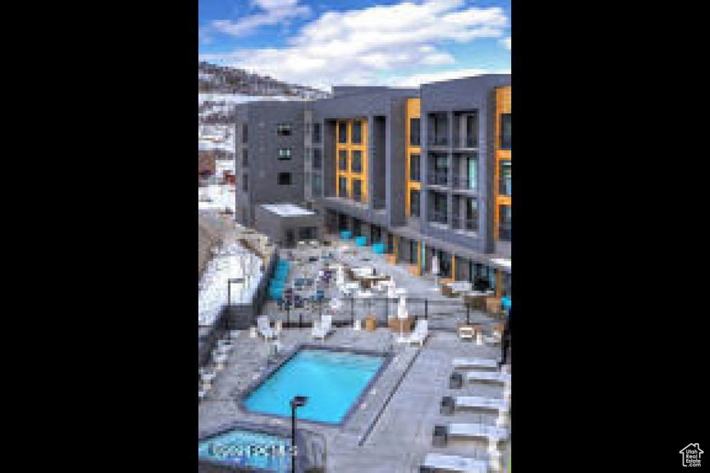 View of swimming pool with a community hot tub