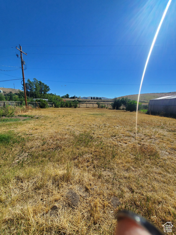 View of yard with a rural view