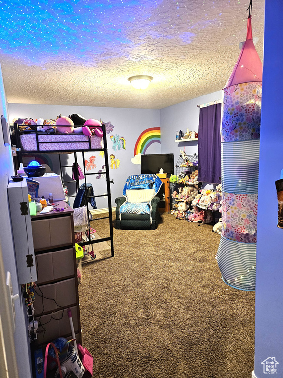 Bedroom featuring a textured ceiling and carpet floors