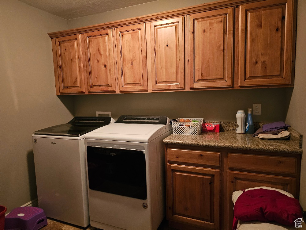 Clothes washing area with washing machine and clothes dryer and cabinets