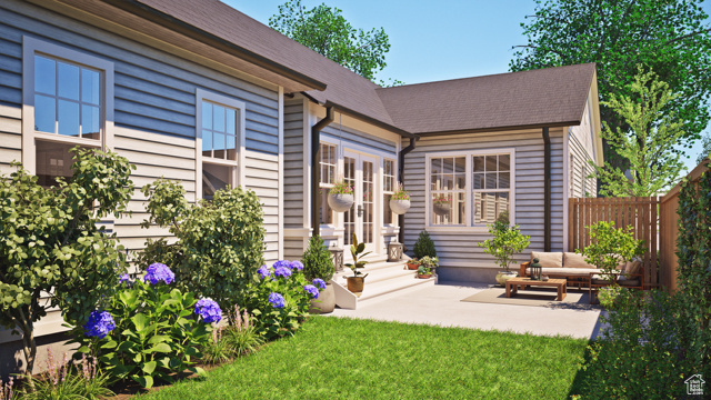 Rear view of house featuring a patio and a yard