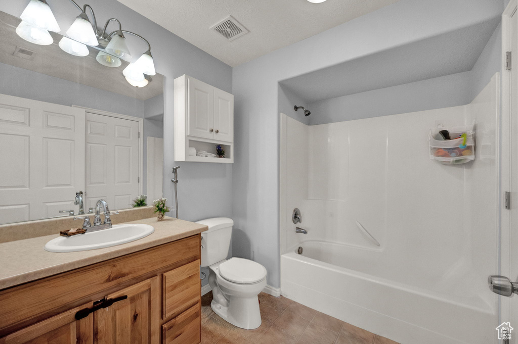 Full bathroom featuring tile patterned flooring, shower / washtub combination, vanity, and toilet