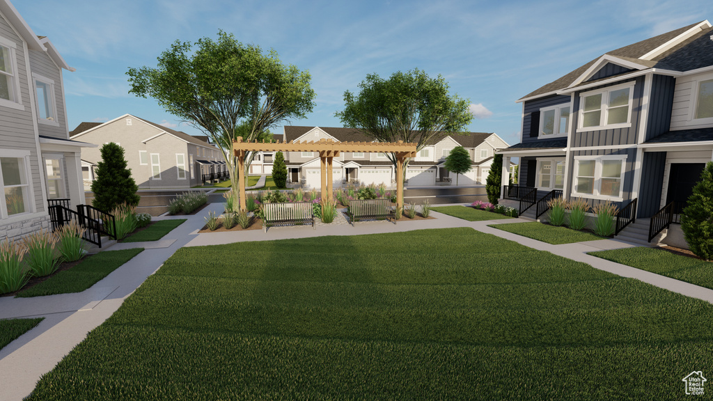 Surrounding community featuring a pergola and a lawn