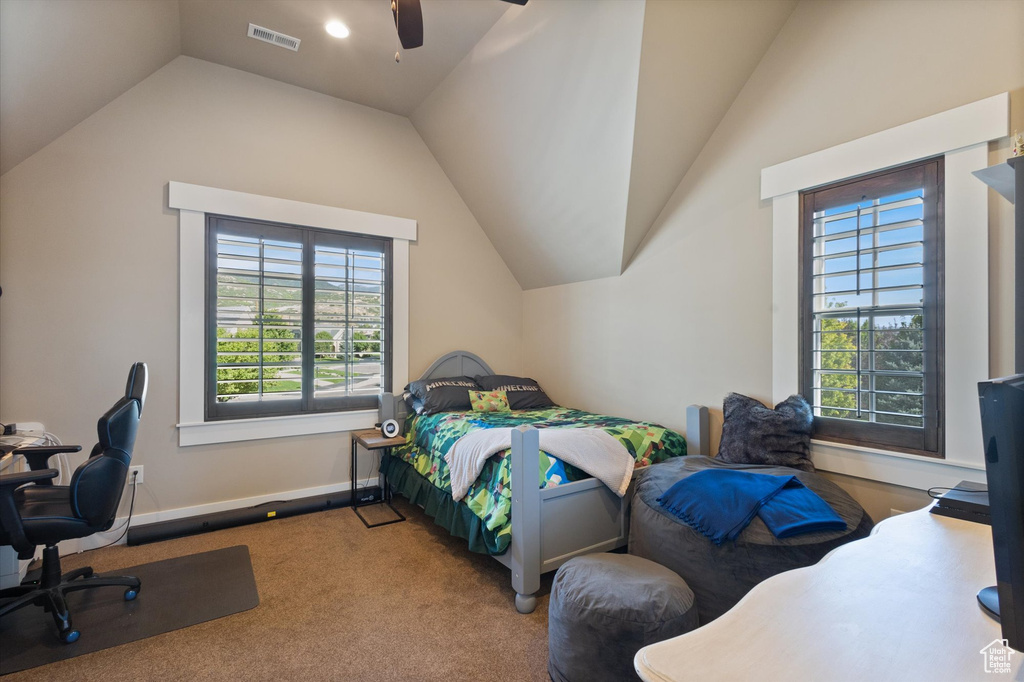 Bedroom featuring carpet, vaulted ceiling, and ceiling fan