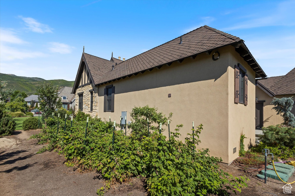 View of side of home featuring a mountain view