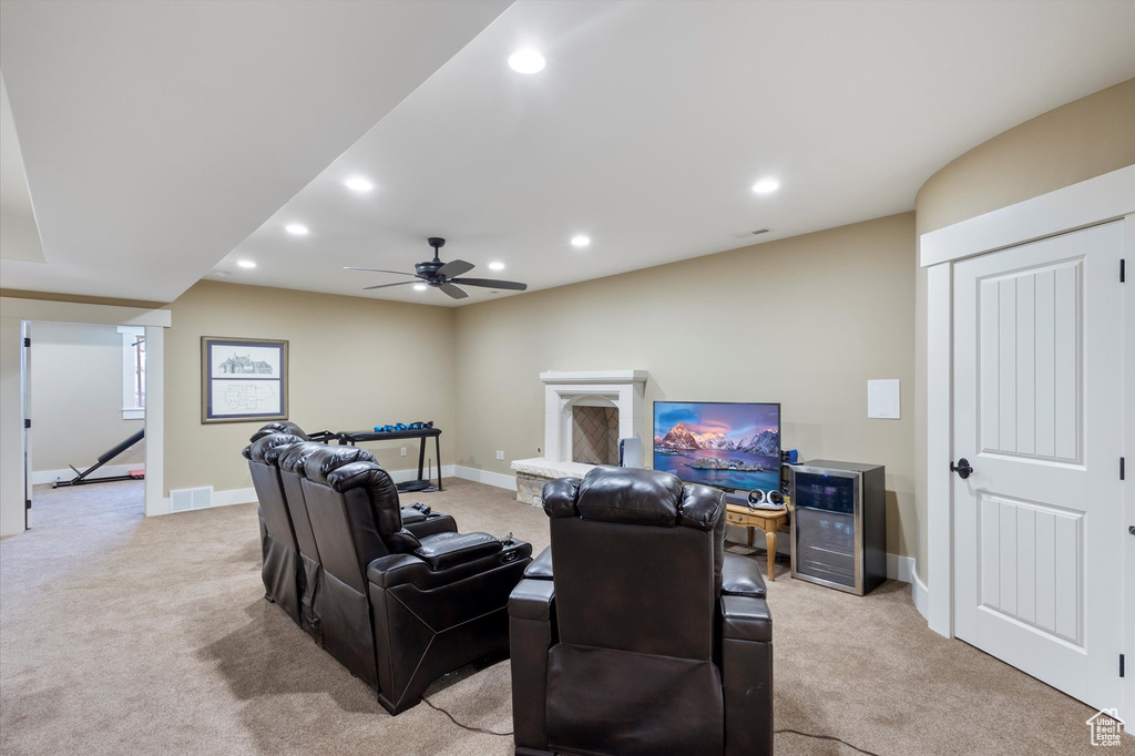 Cinema with ceiling fan, beverage cooler, and light carpet