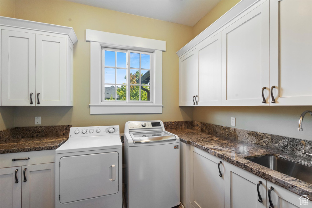 Clothes washing area with sink, washing machine and dryer, and cabinets