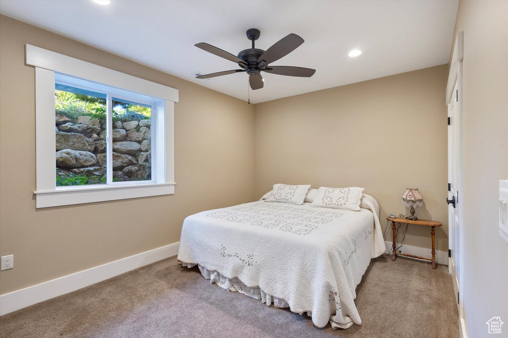 Carpeted bedroom with ceiling fan