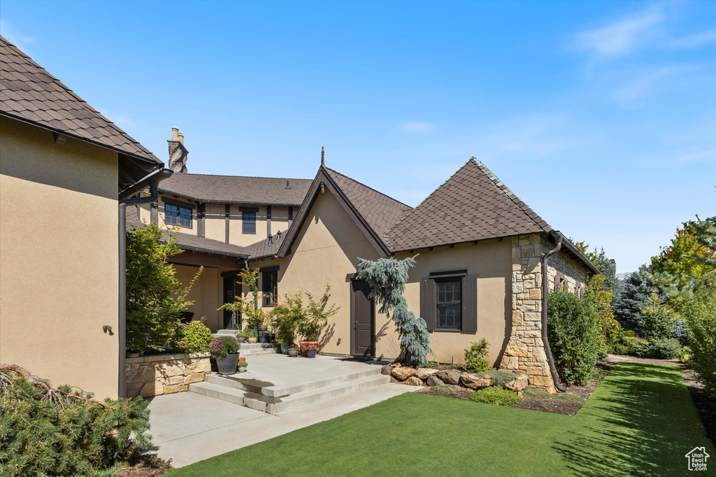 Exterior space featuring a patio and a lawn