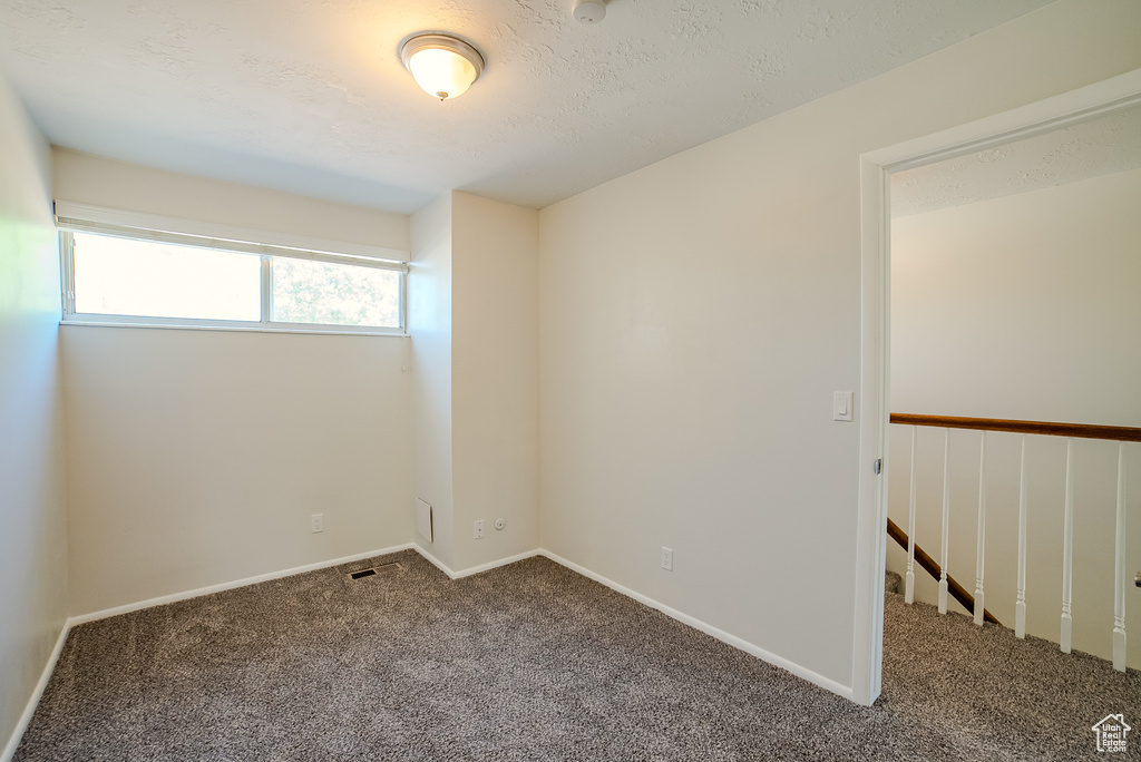 Unfurnished room with carpet floors