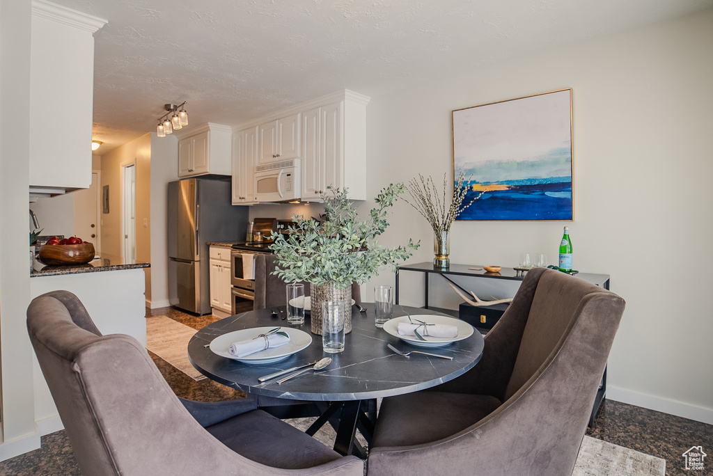 Dining space featuring light tile patterned floors