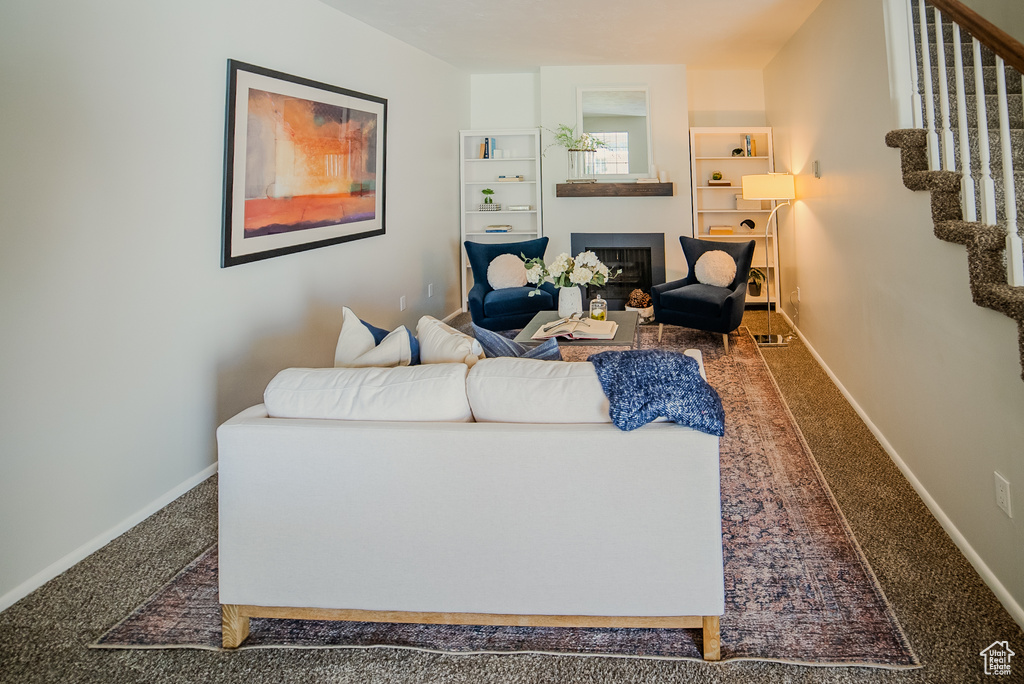 Living room with built in features and carpet floors