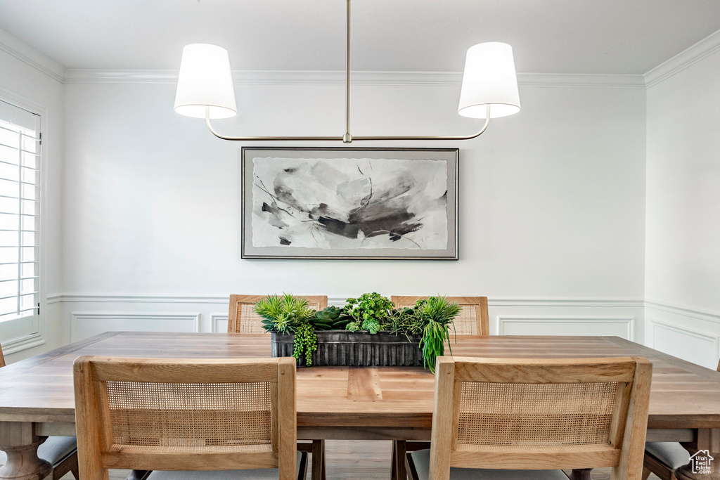 Dining area with plenty of natural light and ornamental molding