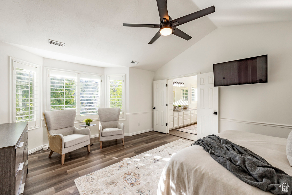 Bedroom with ceiling fan, vaulted ceiling, dark wood-type flooring, and multiple windows