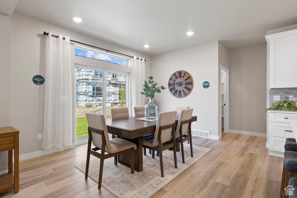 Dining area with light wood-type flooring