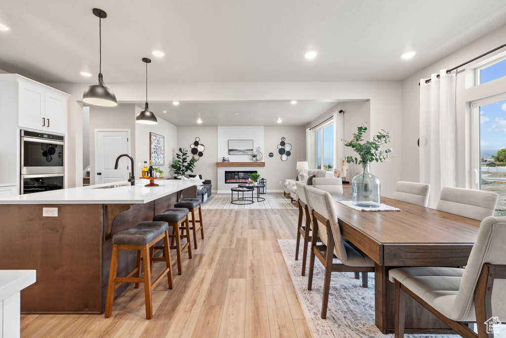 Dining space featuring sink and light hardwood / wood-style floors