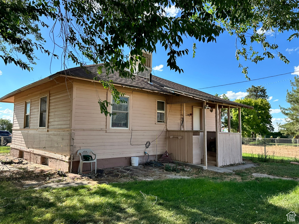 Back of house featuring a lawn