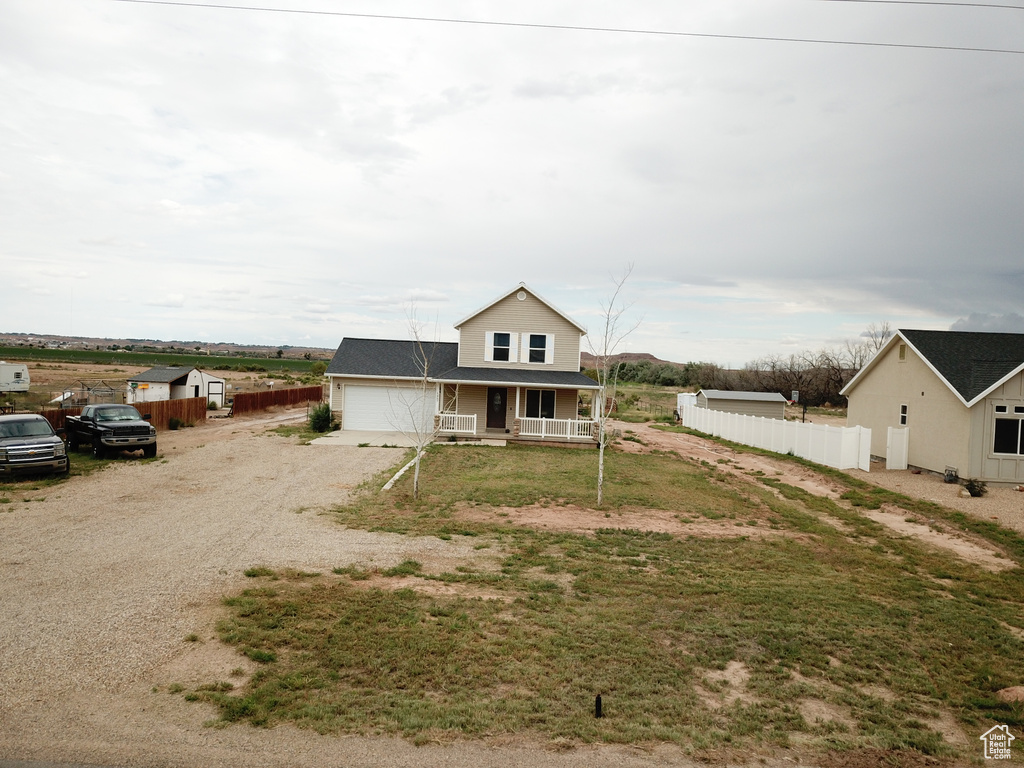 View of front facade featuring a garage and a porch