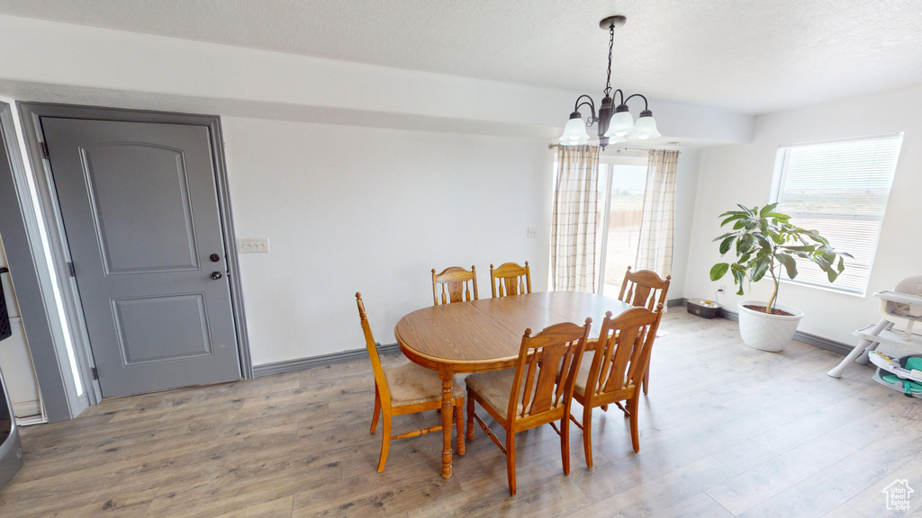 Dining room with a chandelier and wood-type flooring