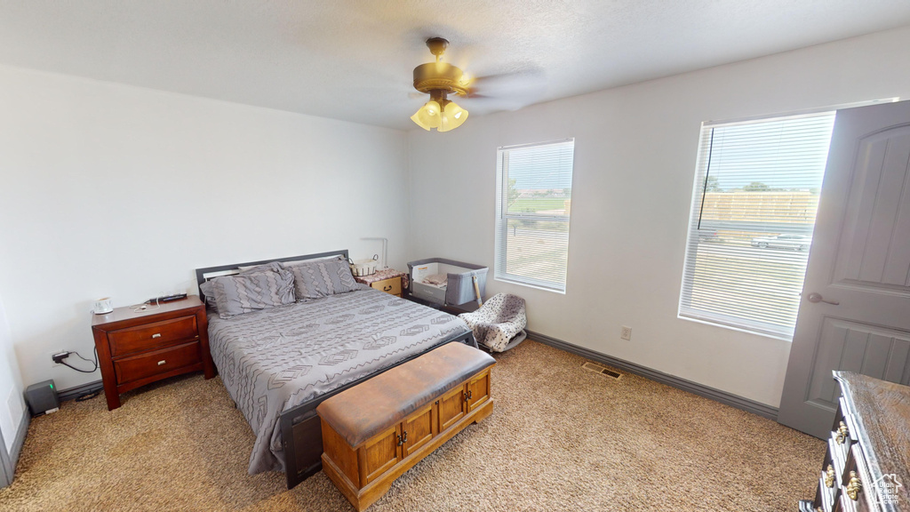 Bedroom featuring ceiling fan and light colored carpet