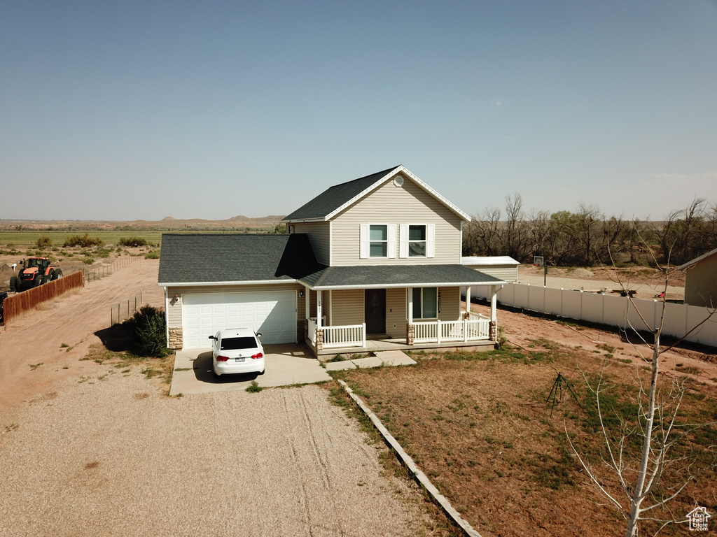 View of front facade with a garage and a porch