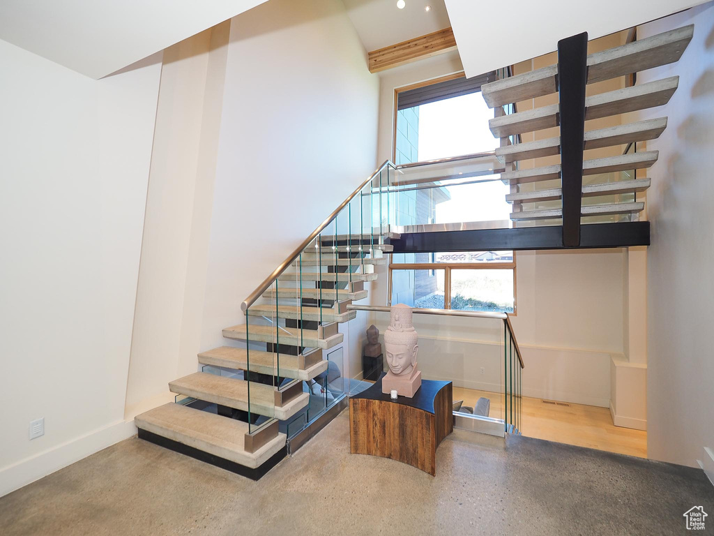 Stairway featuring hardwood / wood-style floors and a wealth of natural light