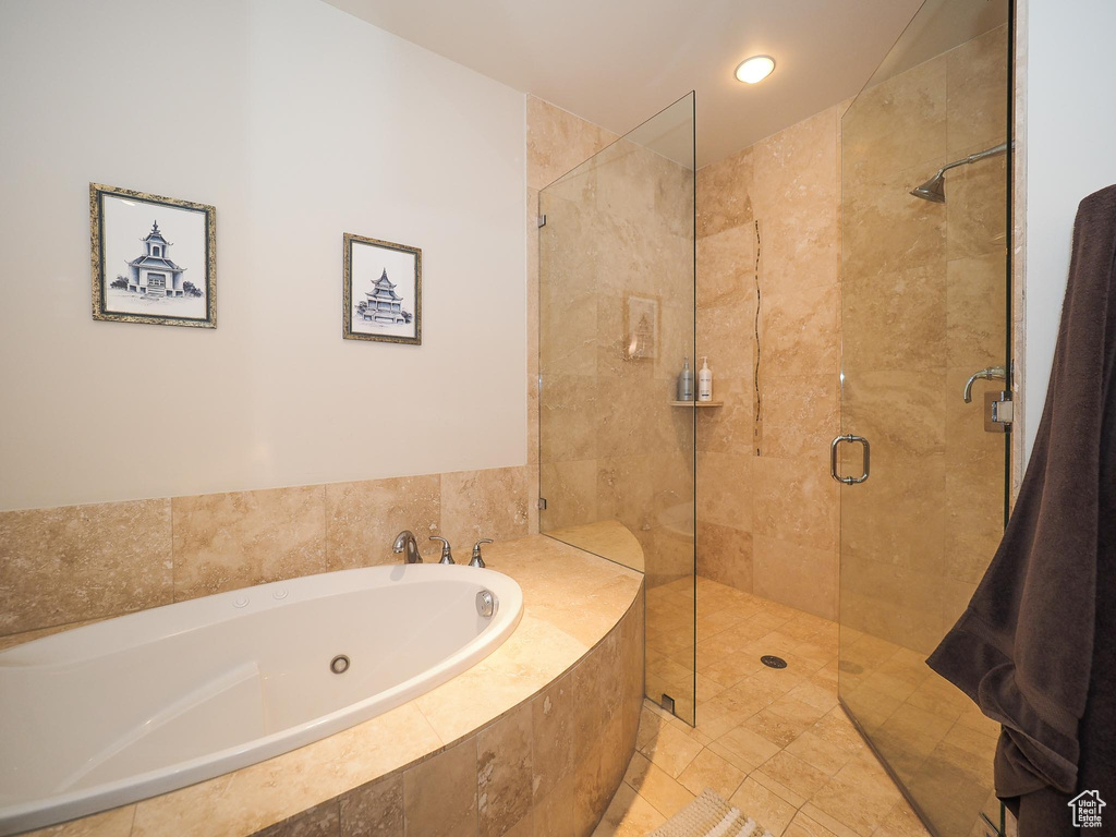 Bathroom featuring independent shower and bath and tile patterned floors