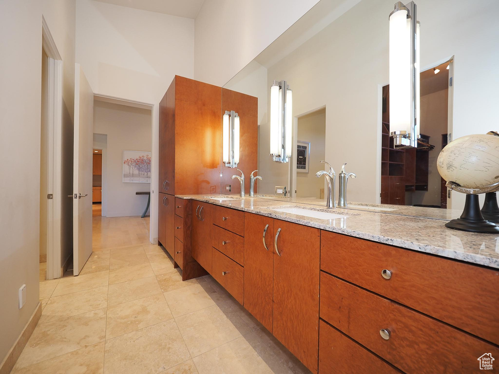 Bathroom with tile patterned floors and vanity