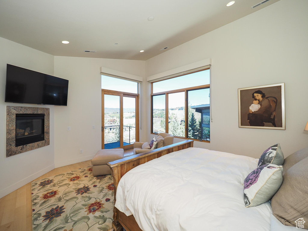 Bedroom featuring vaulted ceiling and hardwood / wood-style floors